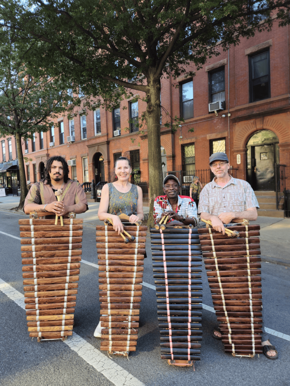 four musicians holding their balafons (west african wooden xlyophones)